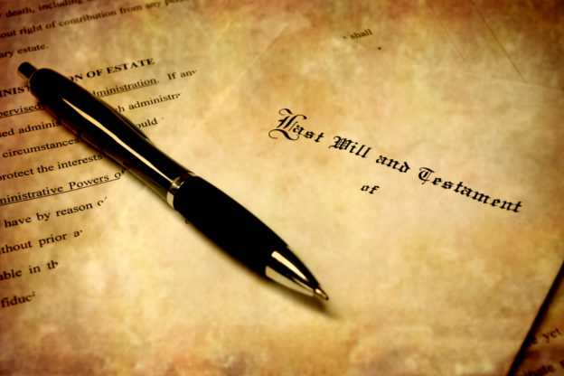 Pen laying on top of a Will for estate planning